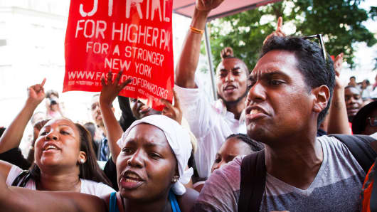 Demonstrators supporting fast food workers protest outside a McDonald's as they demand higher wages and the right to form a union without retaliation Monday, July 29, 2013, in New York's Union Square.