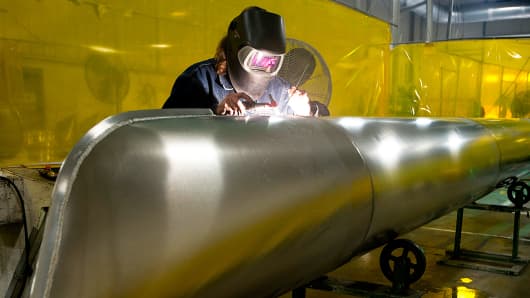 An employee welds a beed onto the nose of an aluminum pontoon during the fabrication process at the Nautic Global Group production facility in Elkhart, Indiana.