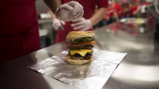 A freshly prepared cheeseburger sits on a kitchen counter at the first U.K. outlet of U.S. burger restaurant chain Five Guys in London, U.K.