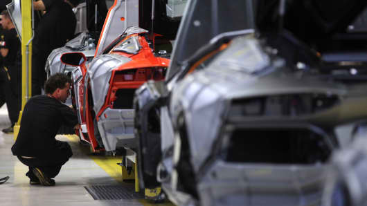 Workers assemble Aventador automobiles on the production line at the Lamborghini factory near Bologna, Italy.