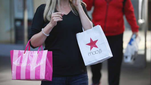 A shopper carries a purchase from Macy's in Chicago, Illinois.