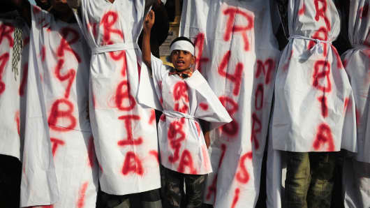 A young boy accompanies activists of the student wing of Islamic political party Jamaat-e-Islami (JI) as they march during a protest rally in support of ousted Egyptian president Mohamed Morsi in Karachi on August 18, 2013.