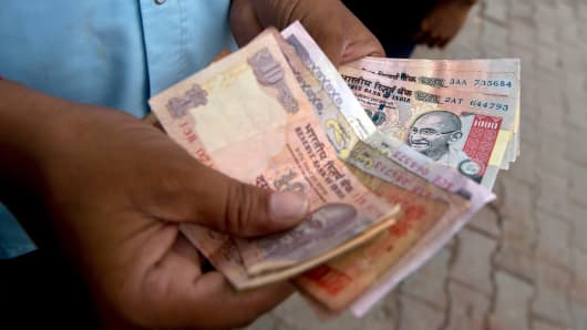 India's rupee has plunged to a record lows against the dollar.