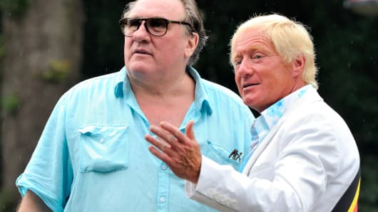 The mayor of Estaimpuis, Daniel Senesael (R), welcomes French actor Gerard Depardieu before a ceremony held in his honor at the Chateau Bourgogne in Estaimpuis on August 24, 2013.
