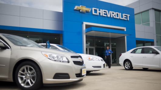 A dealer walks out of the front doors of the Jack Maxton Chevrolet dealership in Columbus, Ohio.