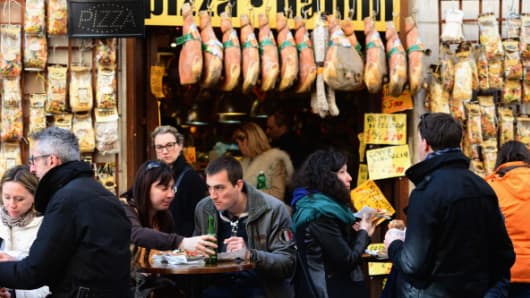 People eat lunch in a cafe in Rome, Italy.
