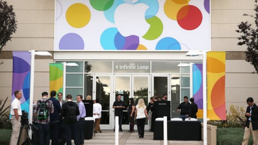 People arrive for an Apple product announcement at the Apple campus in Cupertino, Calif.