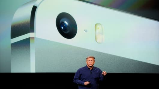 Apple's Philip Schiller introduces a new iPhone 5S during the product announcement.