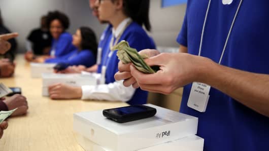People buy the new Apple iPad Air at the Apple Store in New York City.