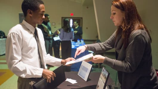A recruiter, right, meets with a job seeker at the Columbus Career Fair in Columbus, Ohio.