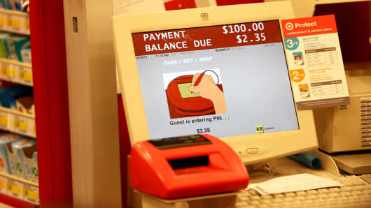 A cash register screen indicates a customer is entering their PIN number at a Target store in Miami.