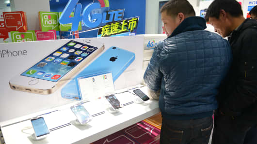 Customers looking at Apple iPhones in a China Mobile store in Shanghai.