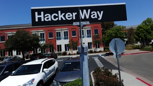 street sign reading 'Hacker Way' is seen in the parking lot of the Facebook headquarters in Menlo Park, California.
