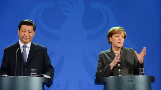 Chinese President Xi Jinping (L) and German Chancellor Angela Merkel address a press conference after a political and economic agreements signing ceremony at the chanellery in Berlin.