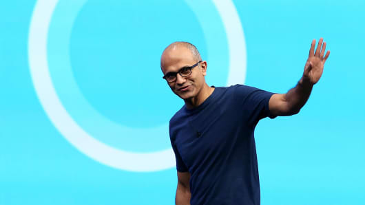 Microsoft CEO Satya Nadella in front of the Cortana logo