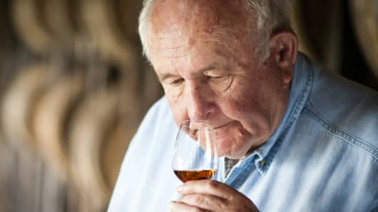 Wild Turkey master distiller Jimmy Russell sniffs a glass of bourbon.