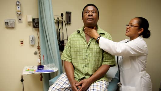 A man who is insured under an insurance plan through the Affordable Care Act receives a checkup from Dr. Peria Del Pino-White at the South Broward Community Health Services clinic on April 15, 2014 in Hollywood, Florida.