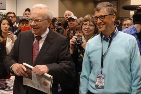 Warren Buffett and Bill Gates prepare to do the 'newspaper toss' at the Berkshire Hathaway Annual Shareholder's Meeting in Omaha, Nebraska.