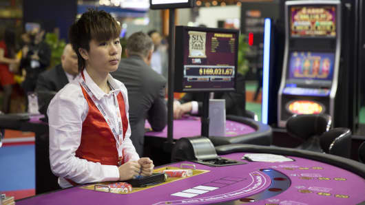 A croupier stands ready at a poker table in the Venetian Macao resort and casino in Macau.
