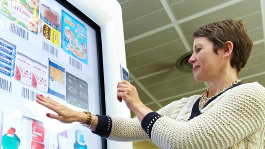 Tesco's virtual grocery store in the Gatwick Airport is an example of how the physical and digital worlds are expected to be fused together in 25 years.