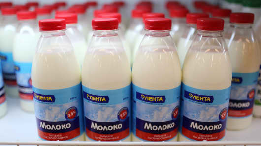 Bottles of milk stand in a chilled cabinet inside a supermarket in Moscow, Russia.