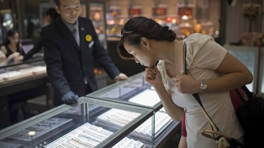 A customer looks at jewelry inside a store in Macau, China.