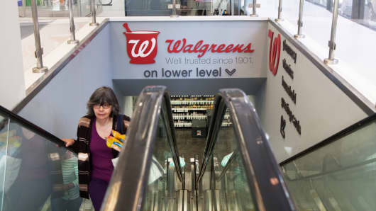 A woman on an escalator in a Walgreens store in New York.