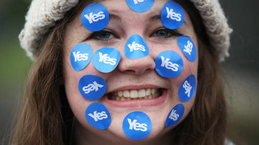 A women wears stickers on her face in Edinburgh, Scotland September 18, 2014.