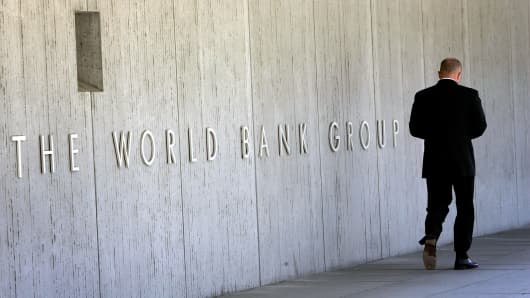   An employee walks outside the headquarters of the World Bank in Washington, in the United States. 