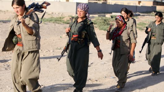 A picture taken on August 21, 2014 shows women Kurdistan Workers Party (PKK) patrolling on the front line in the Makhmur area, near Mosul, during the ongoing conflict against Islamic State (IS) jihadists.