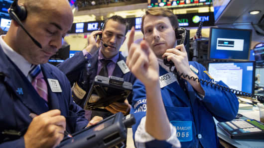 Traders work on the floor of the New York Stock Exchange, Oct. 15, 2014.