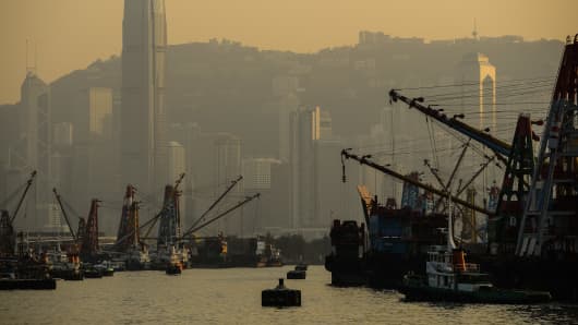 A haze of pollution as the sun sets over the harbour in Hong Kong as thousands of ships burn dirty fuels that have turned the once-fragrant harbor into a city often covered in smog with air pollution killing over 3,000 people yearly.