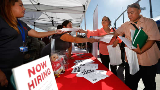 Attendees pick up leaflets at a military veterans' job fair in Carson, California.