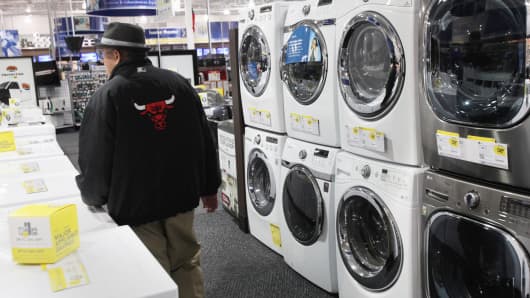 A shopper walks past washer and dryers at a Best Buy store in Northbrook, Illinois.