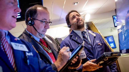 Traders on the floor of the New York Stock Exchange, December 1, 2014.