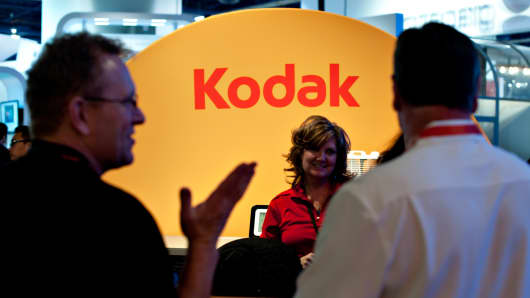 Attendees talk to a company representative in the Eastman Kodak booth at an International Consumer Electronics Show.