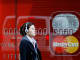 A woman walks past a Westpac bank advertisement in central Sydney, Australia.