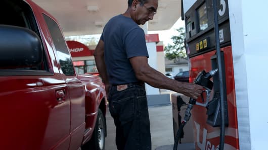 A customer puts gas into a vehicle at the U-gas station in Miami.