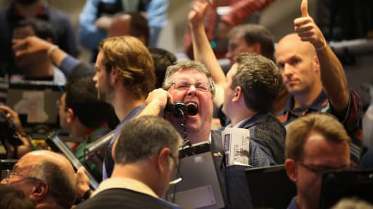 Traders signal offers in the Standard & Poor's 500 stock index options pit at the Chicago Board Options Exchange (CBOE) following the Federal Open Market Committee meeting in Chicago, Illinois.