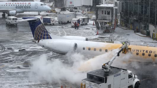 A plane is de-iced at LaGuardia Airport in New York, Jan. 26, 2015.