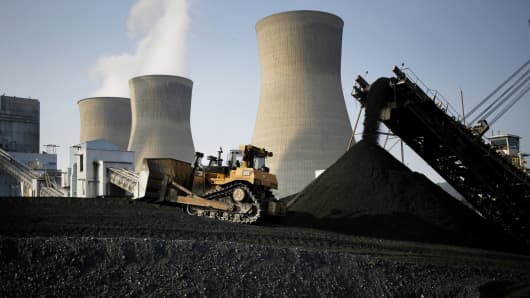 A bulldozer moves coal that will be burned to generate electricity at the American Electric Power coal-fired power plant in Winfield, West Virginia.
