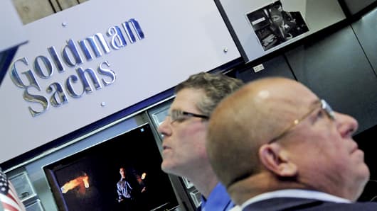 Traders work at the Goldman Sachs booth on the floor of the New York Stock Exchange.
