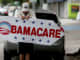 A man holds a sign directing people to an insurance company where they can sign up for the Affordable Care Act, in Miami.