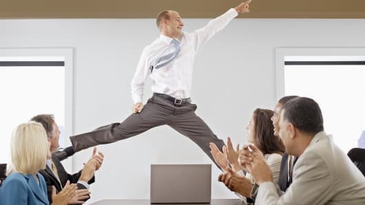 Businessman jumping during meeting