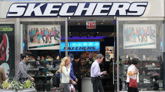 Pedestrians walk by a Skechers store in New York.