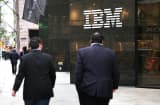 Pedestrians walk past the IBM building in New York.
