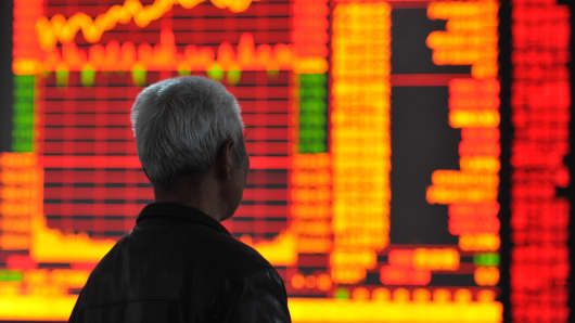Investors observe stock prices in Huaibei, China.