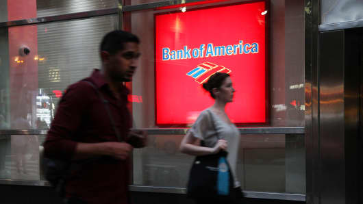 Pedestrians pass in front of a Bank of America branch in New York.