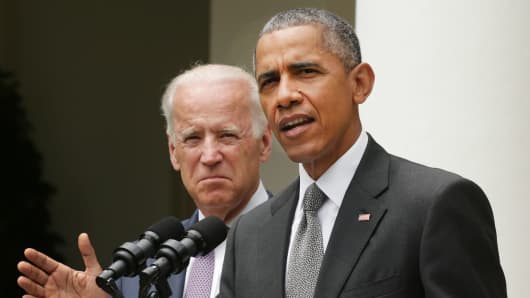 President Barack Obama, flanked by Vice President Joe Biden, gives a statement on the Supreme Court health care decision in the Rose Garden at the White House on June 25, 2015 in Washington.