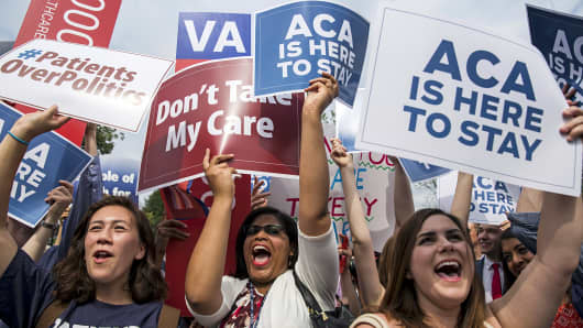 Supporters of the Affordable Care Act celebrate as the opinion for health care is reported outside the Supreme Court in Washington, June 25, 2015.